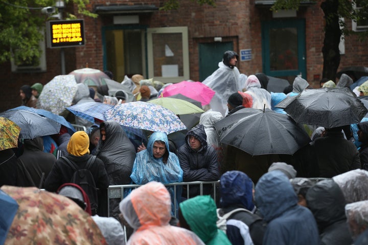 Migrants wait outside the Central Registration Office for Asylum Seekers of the State Office for Health and Social Servi