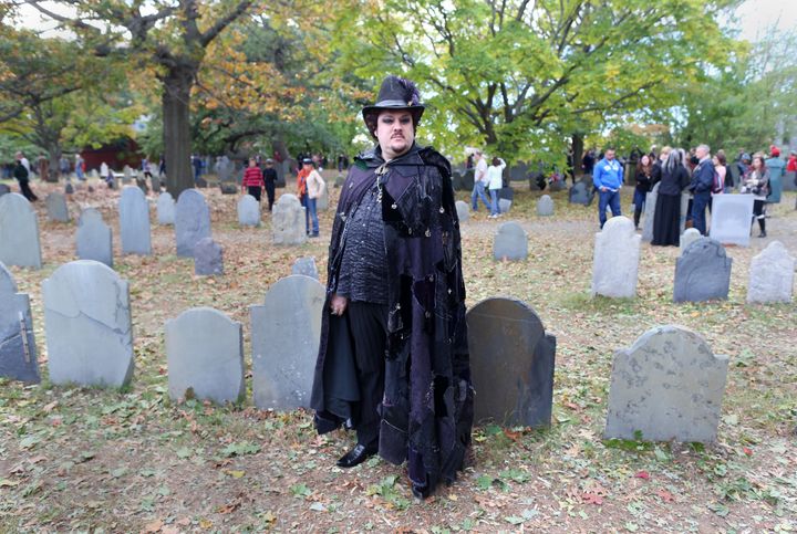 Warlock Christian Day poses in a graveyard.