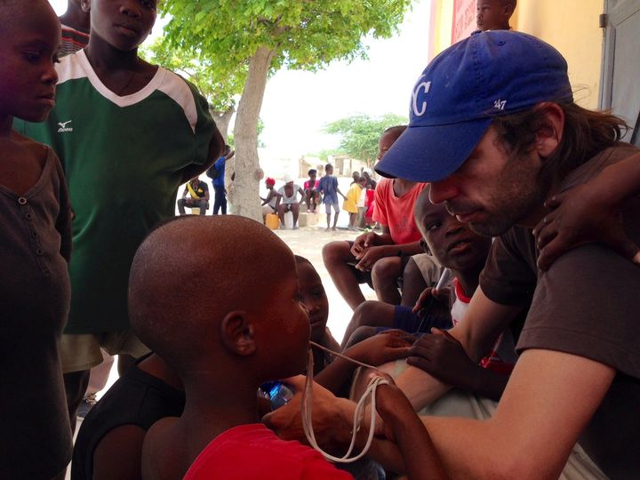 Jackson in Haiti participating in his organization's deworming initiative.