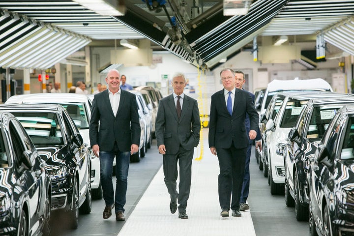 Mueller (center) with Bernd Osterloh, labor leader of Volkswagen AG (left), and Stephan Weil, prime minister of the German st