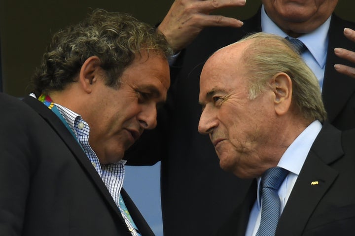 Blatter (right) speaks with UEFA president Michel Platini at the Fonte Nova Arena on June 16, 2014, during the 2014 FIFA World Cup.