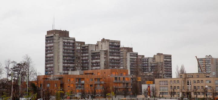 New council flats in front of shabby apartment houses from the 1960s and 1970s in Clichy-sous-Bois.