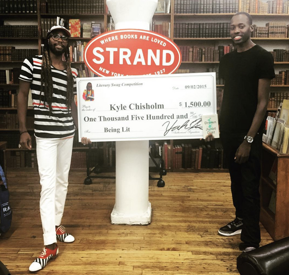 Israel presenting the winner of the 2015 #LiterarySwag contest, Kyle Chisholm, with a $1,500 check.