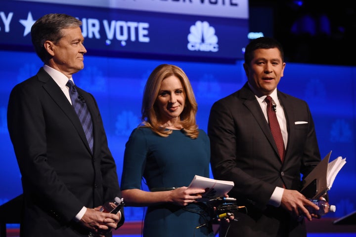 Moderators John Harwood, Beck Quick, and Carl Quintanilla on stage at the Republican debate. 