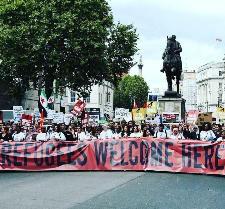 Passarlay, pictured here in the first row on the right, led a march in London welcoming refugees into the country and urging the U.K. government to take in more.