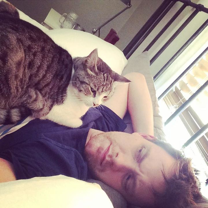 Arden poses with his cat, Eloise. 