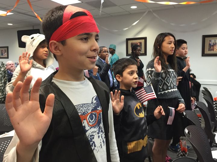 Ahad Kahattak, 11, and Ahmad Kahattak, 8, of Pakistan take the oath of allegiance during a U.S. naturalization ceremony.