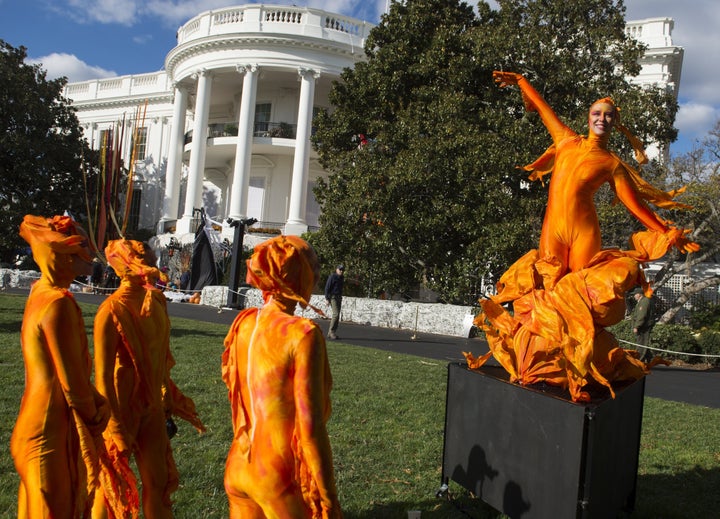 A woman dressed as fire performs on the South Lawn of the White House.