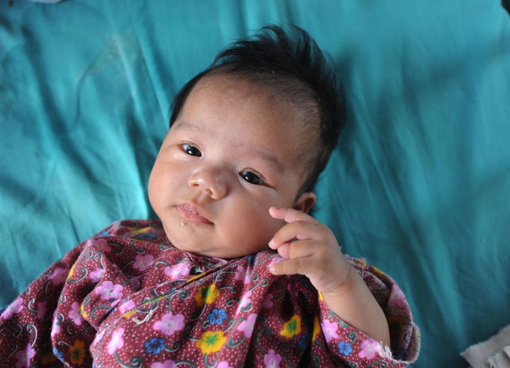 A Chinese baby rests in its cot at an orphanage in Wuhu, in eastern China's Anhui province on August 7, 2009.