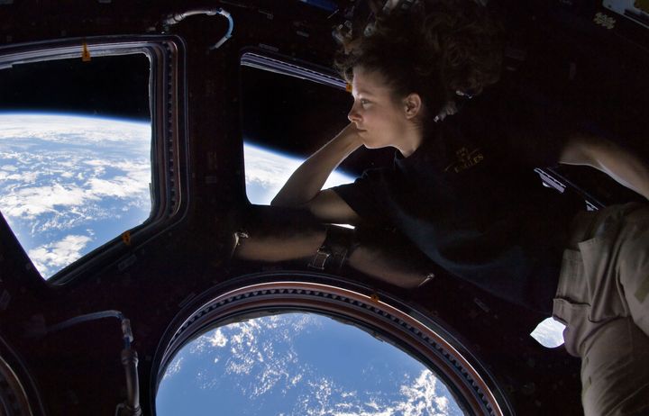 NASA astronaut Tracy Caldwell Dyson, Expedition 24 flight engineer, looks through a window in the Cupola of the International Space Station in September 2010.