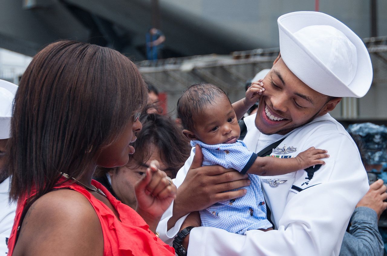 Sailors reunite with their families after the arrival of the aircraft carrier USS Ronald Reagan (CVN 76) to Fleet Activities Yokosuka, Japan on Oct. 1, 2015.