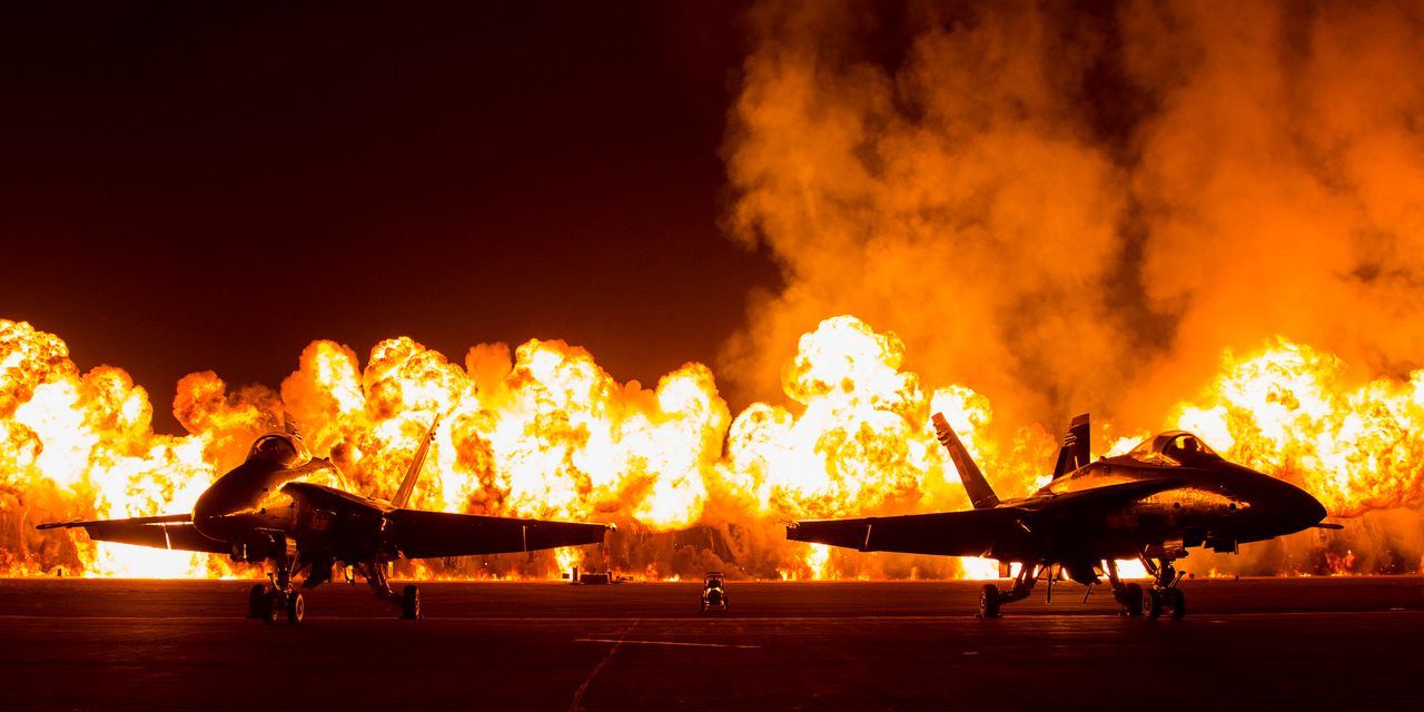 Two FA-18 Jets are displayed in front of the Wall of Fire during the Marine Corps Community Services sponsored 2015 Air Show aboard Marine Corps Air Station Miramar in San Diego, California, Oct. 3, 2015