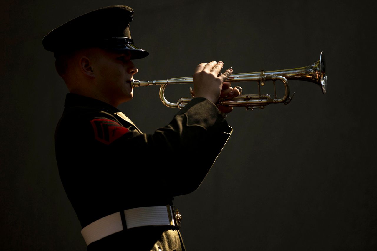 Corporal Derek Detzler, a bugler with the 2nd Marine Division Band, performs Taps during the 32nd Beirut Memorial Observance Ceremony in Jacksonville, North Carolina, Oct. 23, 2015. The ceremony was held to honor the memory of service members, most of whom were from 1st Battalion, 8th Marines, 24th Marine Amphibious Unit, killed in the 1983 Marine Barracks bombing in Beirut, Lebanon.