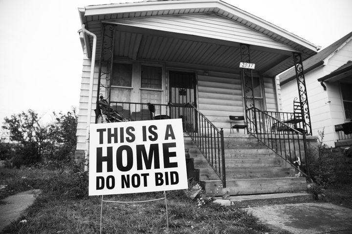 The Tricycle Collective gave families yard signs to dissuade people from bidding on their homes in the auction. 