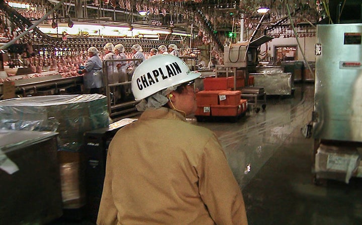 Tyson Foods Chaplain Melissa Brannan walks the production line at a food processing plant in Springdale, Arkansas.