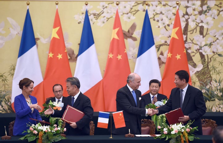 Chinese and French officials attend an agreement session in Paris on Nov. 2 to tackle climate change. Agreements like this, a new study claims, could deliver trillions of dollars to the U.S.