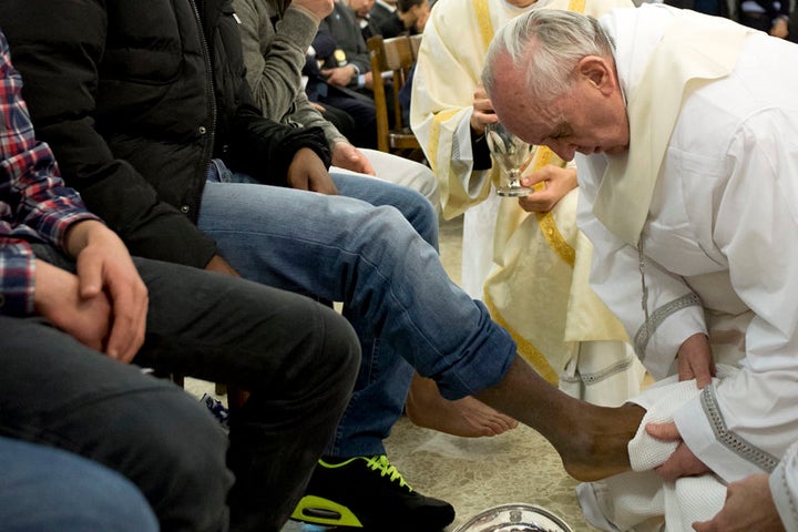 Pope Francis washes the foot of a prisoner at Casal del Marmo youth prison in Rome on March 28, 2013. Two young women were among 12 people whose feet Pope Francis washed and kissed at a traditional ceremony in a Rome youth prison on Holy Thursday, the first time a pontiff has included females in the rite.