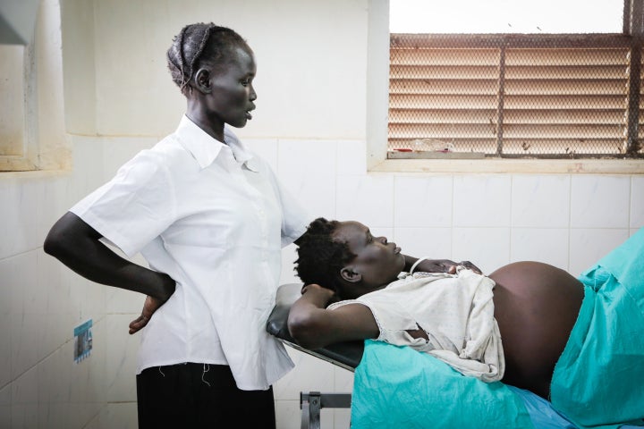 Deng Kuol Nyanaguek, 30, and her sister-in-law wait at a hospital. Nyanaguek is pregnant for the sixth time and expecting twi