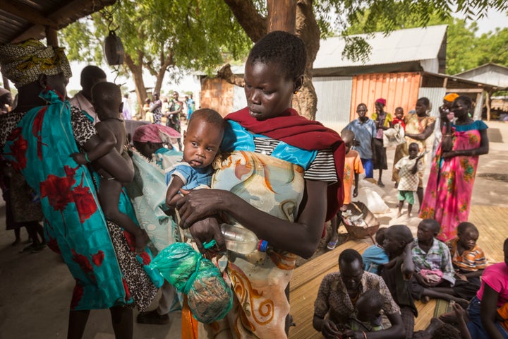 Nyagai Koang and her six-month-old baby Gawiech Keah Kuok wait for medical checks in Leer, South Sudan.