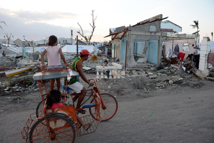 A resident-survivor of super Typhoon Haiyan, peddals his bicycle past destroyed houses to transport passengers, along the coastal area of Tacloban City , Leyte province, in central Philippines on February 15, 2014. The United Nations warned on February 15 that millions of survivors of the Philippines' deadliest typhoon were still without adequate shelter 100 days after the disaster.