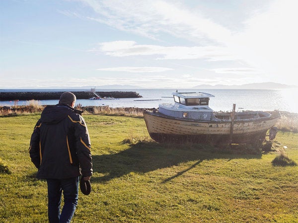 Mansour examining an abandoned boat. He told me, "I've been traveling my whole life, nothing's new to me. It would be very di