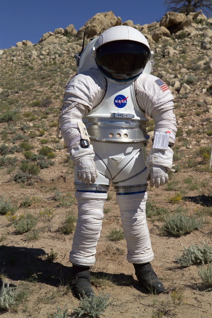 A NASA employee equipped with a Mark-III suit takes a stroll in Arizona's high desert.