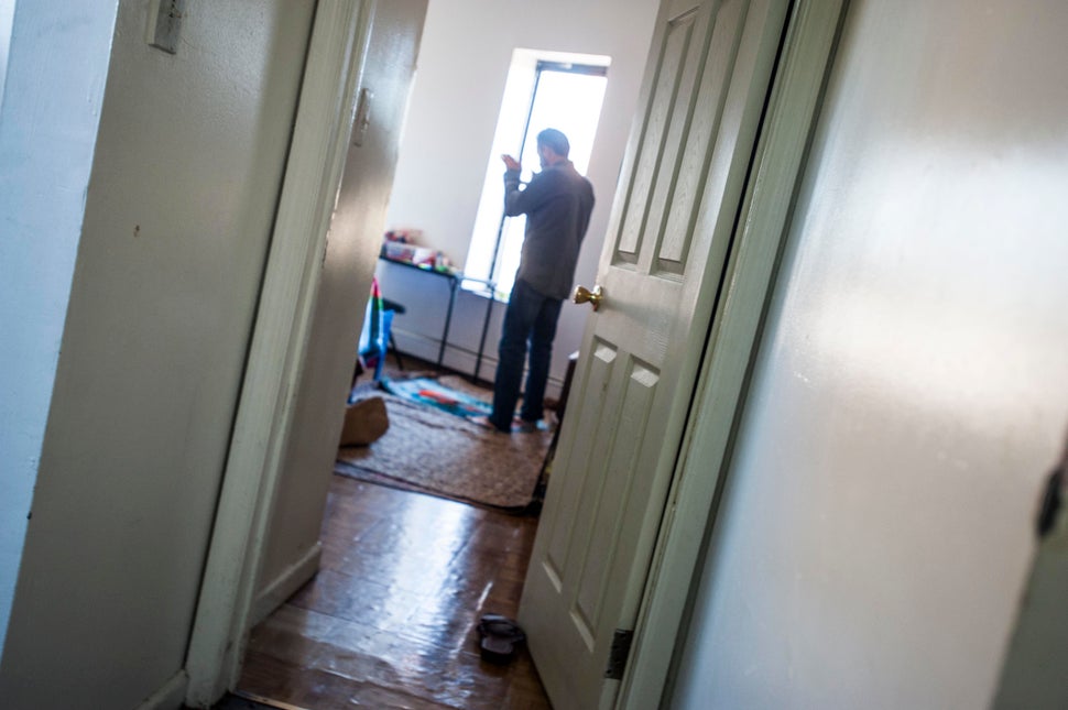 Mohamed Darbi takes a break to pray in his bedroom.