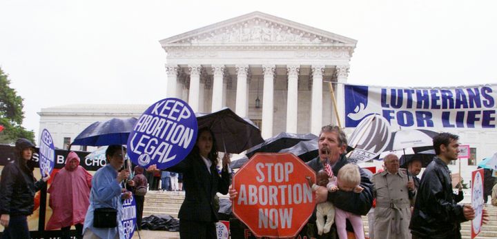 UNITED STATES - APRIL 25: Pro-choice and anti-abortion activists demonstrate in front of the Supreme Court building as arguments on "partial birth" abortion are heard before the court.