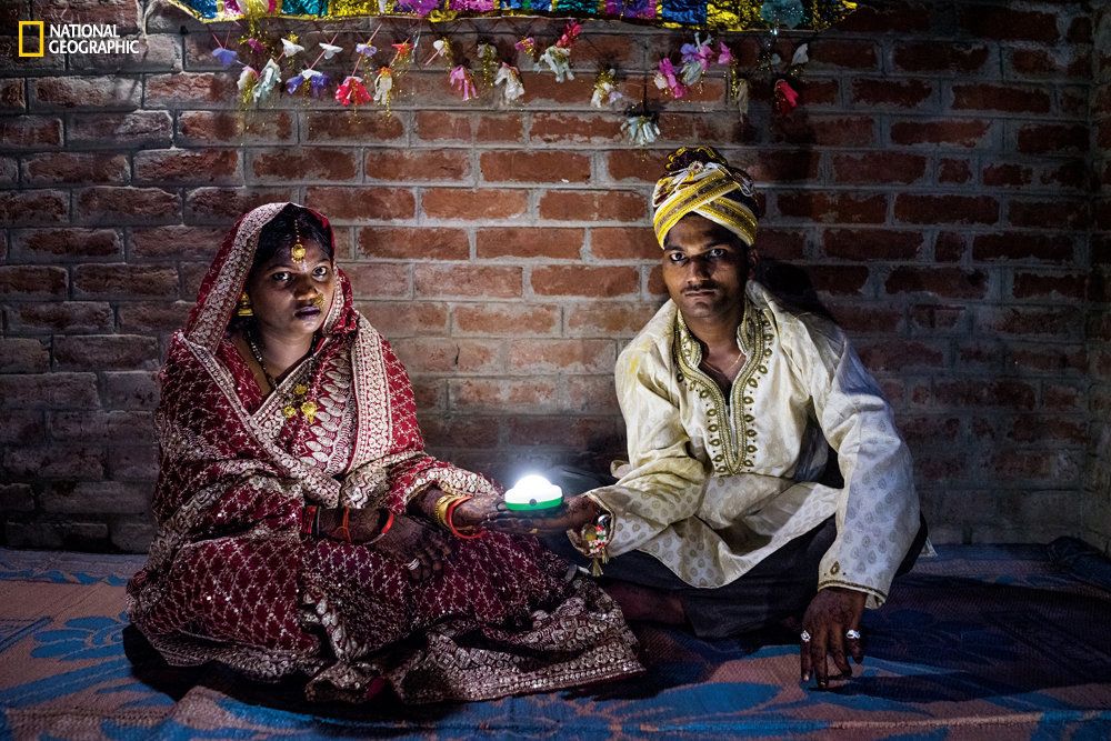 Holding a solar-powered lamp, Soni Suresh, 20, and Suresh Kashyap, 22, celebrate their marriage ceremony in Uttar Pradesh, where 20 million households lack electricity.