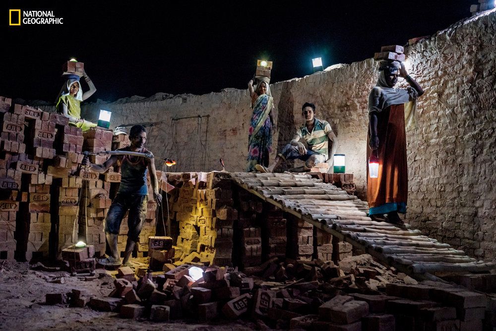 At a brick kiln in India's rural state of Uttar Pradesh, workers use solar lanterns to illuminate their paths.