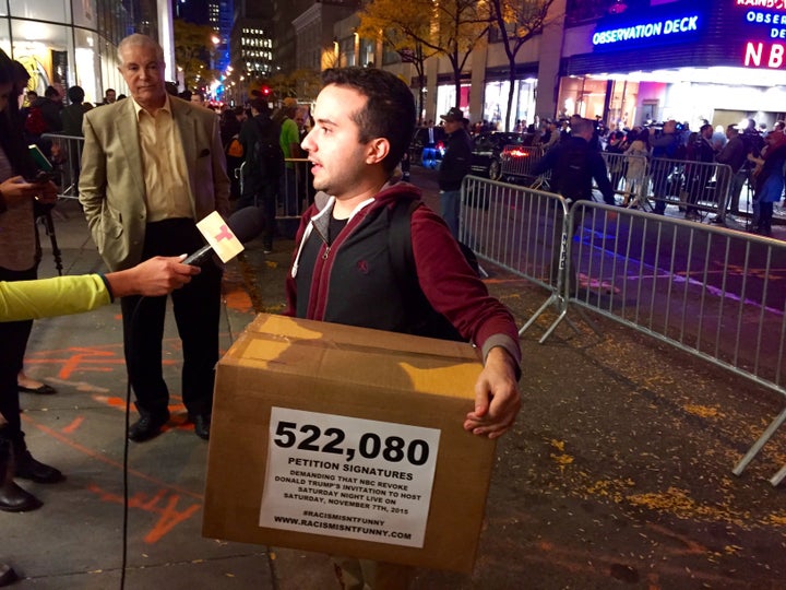 Activist Juan Escalante prepares to deliver petitions bearing 522,080 signatures asking NBCUniversal to rescind its invitation to bring on Donald Trump as a guest host this week on "Saturday Night Live."