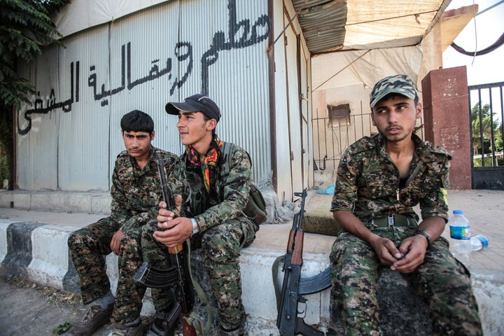 Kurdish People's Protection Units, or YPG, fighters rest in Tal Abyad, Syria on June 19, 2015.