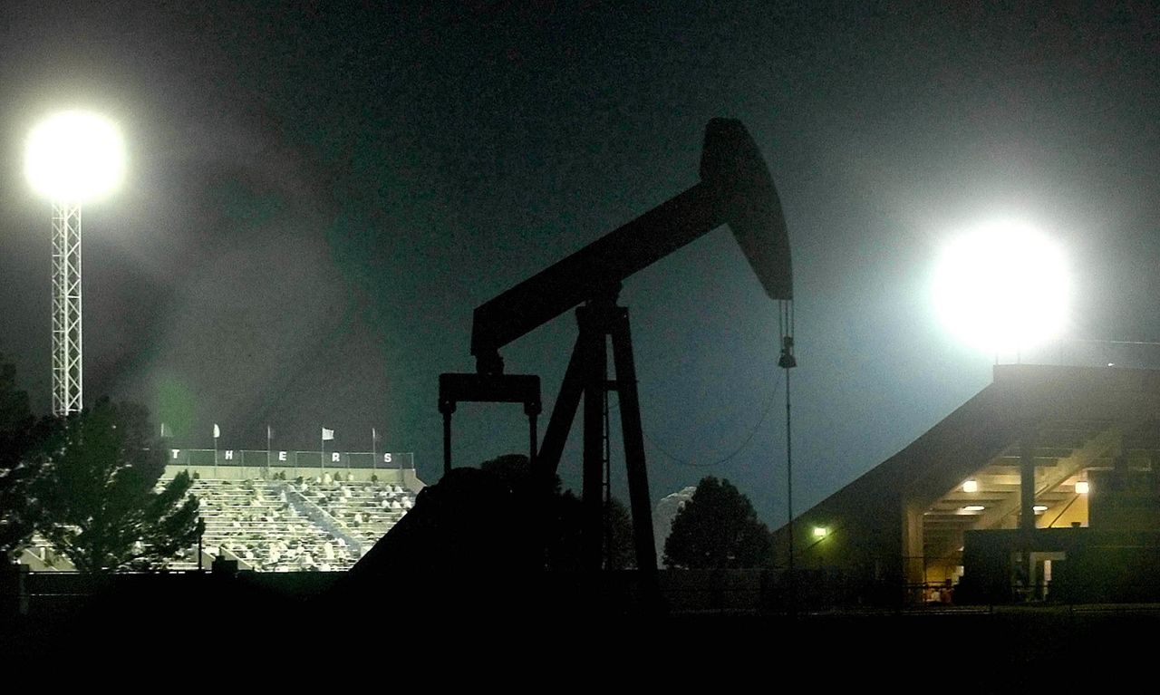 An oil pump outside the Permian High School football stadium in Odessa, Texas. The school was the subject of the book and movie "Friday Night Lights," which showcased the passion and craze around Texas high school football.