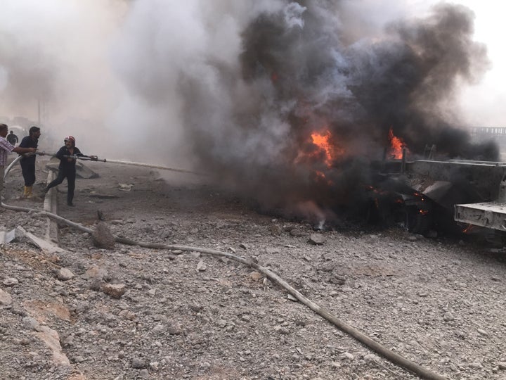 Firefighters extinguish the fire after a car bomb attack on YPG headquarters in Hasakah, Syria on September 15, 2015. At leas