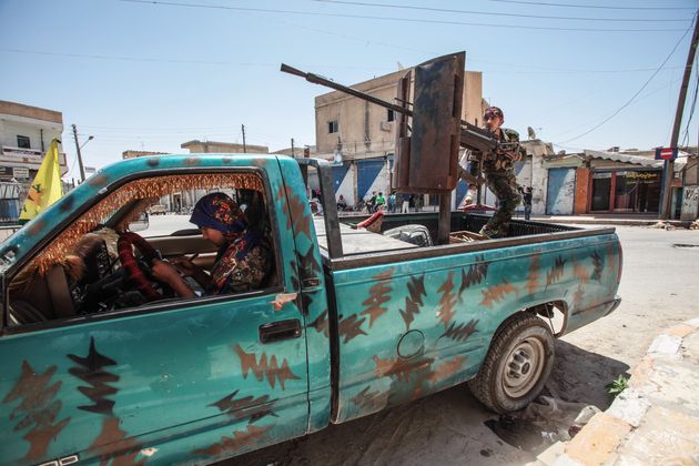 <span class='image-component__caption' itemprop="caption">YPG fighters in downtown Tal Abyad, Syria on June 19, 2015.</span>