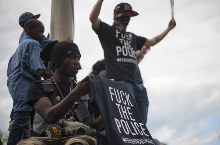 Demonstrators protest in front of City Hall in Baltimore the day after six police officers were charged in the death of Freddie Gray.