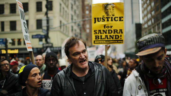 Quentin Tarantino (C) takes part in a march against police brutality called 'Rise up October' on October 24, 2015, in New York.