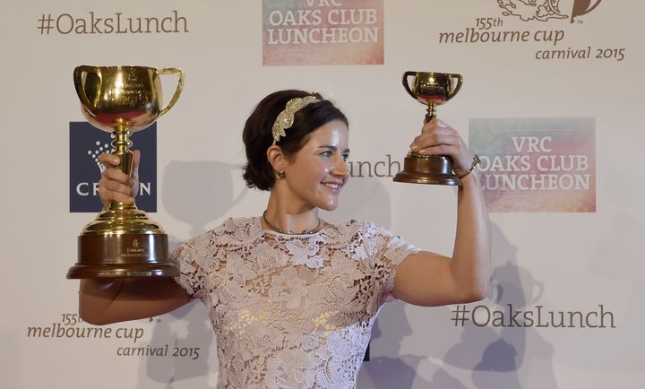 Australian jockey Michelle Payne poses with the winner's trophy during a Melbourne Cup Carnival press conference in Melbourne on November 4, 2015, after she became the first female jockey to win Australia's 154-year-old Melbourne Cup when she rode outsider Prince of Penzance to victory at Flemington on November 3.