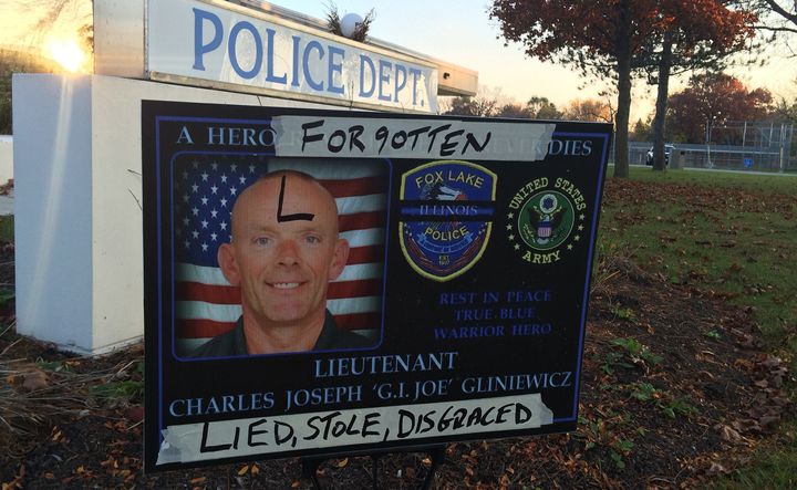 A sign honoring Lt. Joseph 'G.I. Joe' Gliniewicz is defaced outside Fox Lake, Ill. Officials say the late officer committed a carefully staged suicide, disguised to look like a murder, in an attempt to distract investigators from crimes he'd committed.
