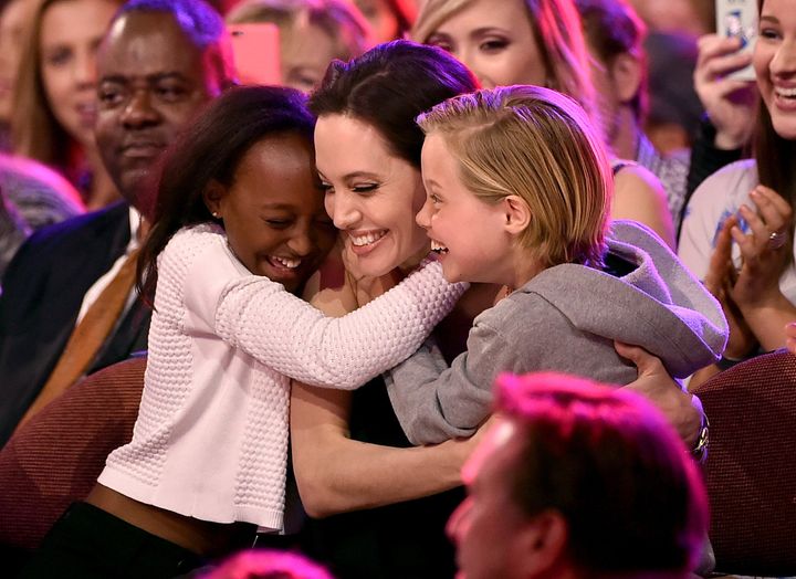 INGLEWOOD, CA - MARCH 28: Actress Angelina Jolie hugs Zahara Marley Jolie-Pitt (L) and Shiloh Nouvel Jolie-Pitt (R) after winning award for Favorite Villain in 'Maleficent' during Nickelodeon's 28th Annual Kids' Choice Awards held at The Forum on March 28, 2015 in Inglewood, California. (Photo by Kevin Winter/Getty Images)