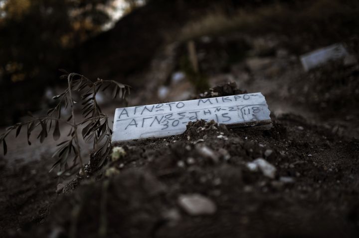 A piece of marble reading 'Unidentified child' is placed over the grave of a child who drowned on its way from Turkey to the Greek island of Lesbos, at a makeshift cemetery in Mytilene, on the island of Lesbos, on November 4, 2015.