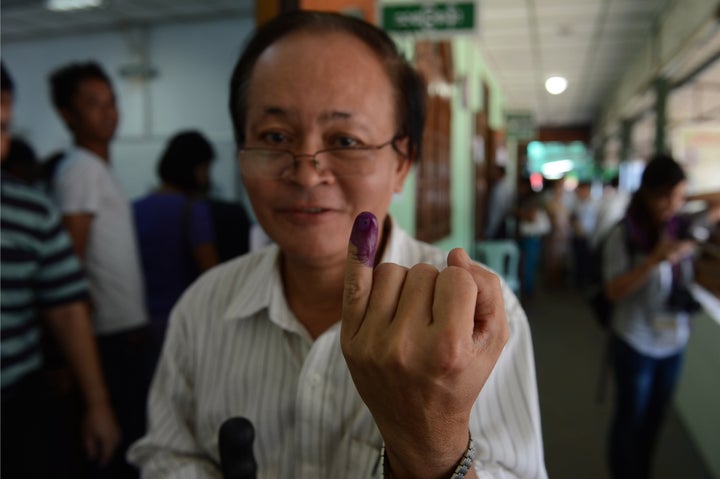 A Myanmar voter displays his inked finger after casting his ballot at a polling center in Yangon on November 8, 2015.