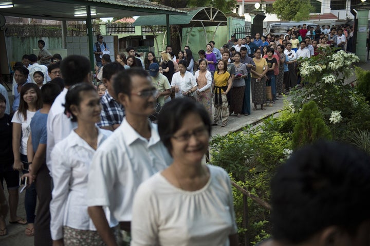 People queue to cast their vote at a polling station in Yangon on November 8, 2015.