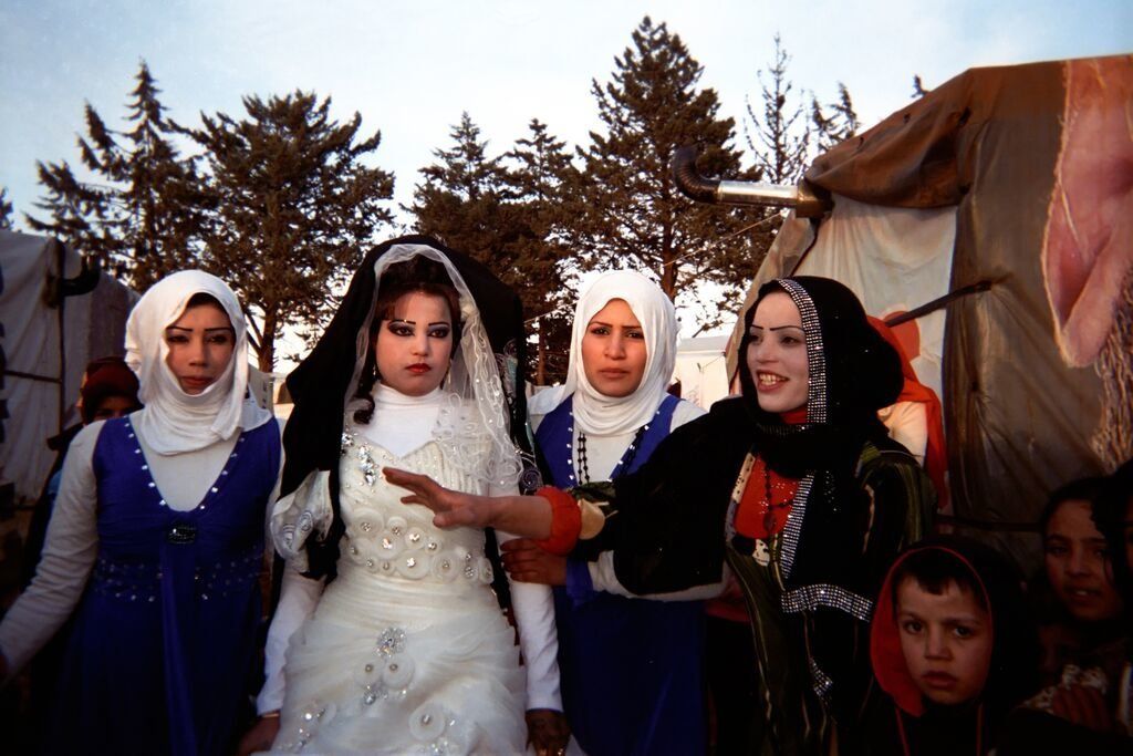 Shot by Ahmad, age 12, from Raqqa Governorate, Syria. Women and children attend a wedding in an informal settlement in the Bekaa Valley, Lebanon, in 2014.