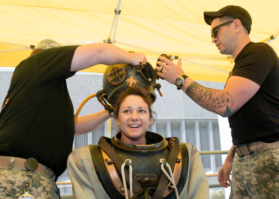 Sgt. Dagan Indeck assists Navy Diver 2nd Class Valerie De Freitas during a Mark V familiarization dive to commentate the Year