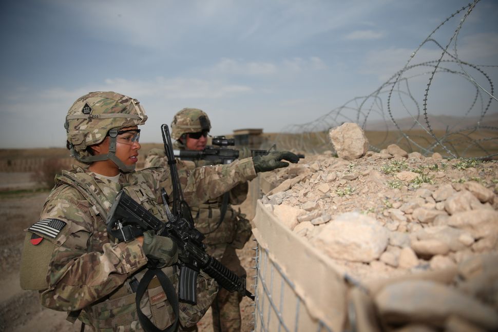 U.S. Army 1st Lt. Audrey Griffith points out an area of interest during a force protection drill to Spc. Heidi Gerke along th