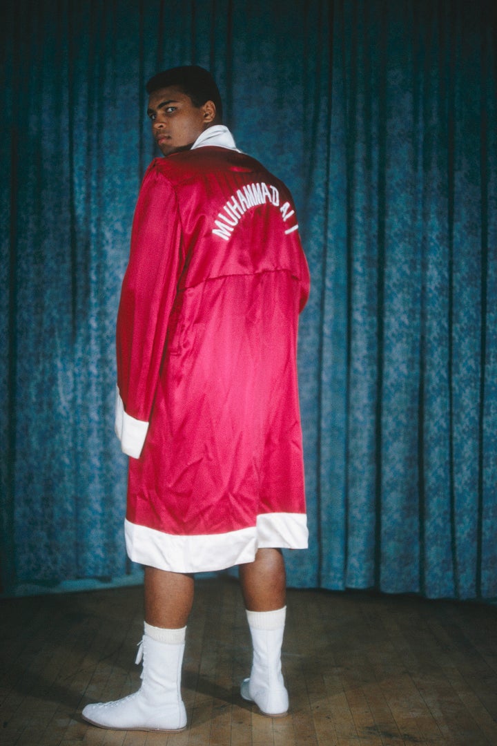 Muhammad Ali poses for a portrait in his robe in 1964.