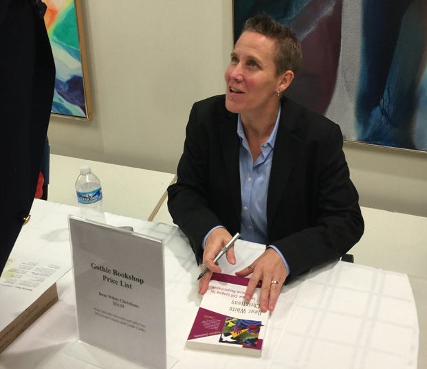Drake University ethicist Jennifer Harvey, signs her book "Dear White Christians," during the Race & Faith Dialogue serie