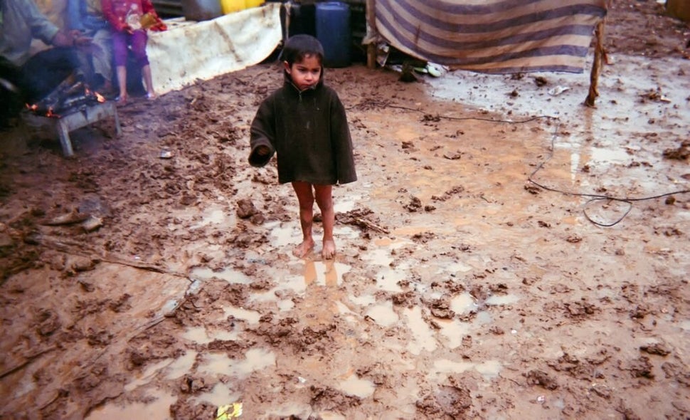 Shot by Moustafa, age 12, from Hama Governorate, Syria.<strong><br></strong> A young boy who is wearing neither pants no