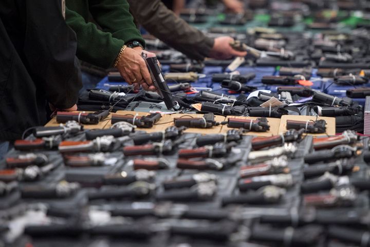 People look at handguns during a gun show in Chantilly, VA.